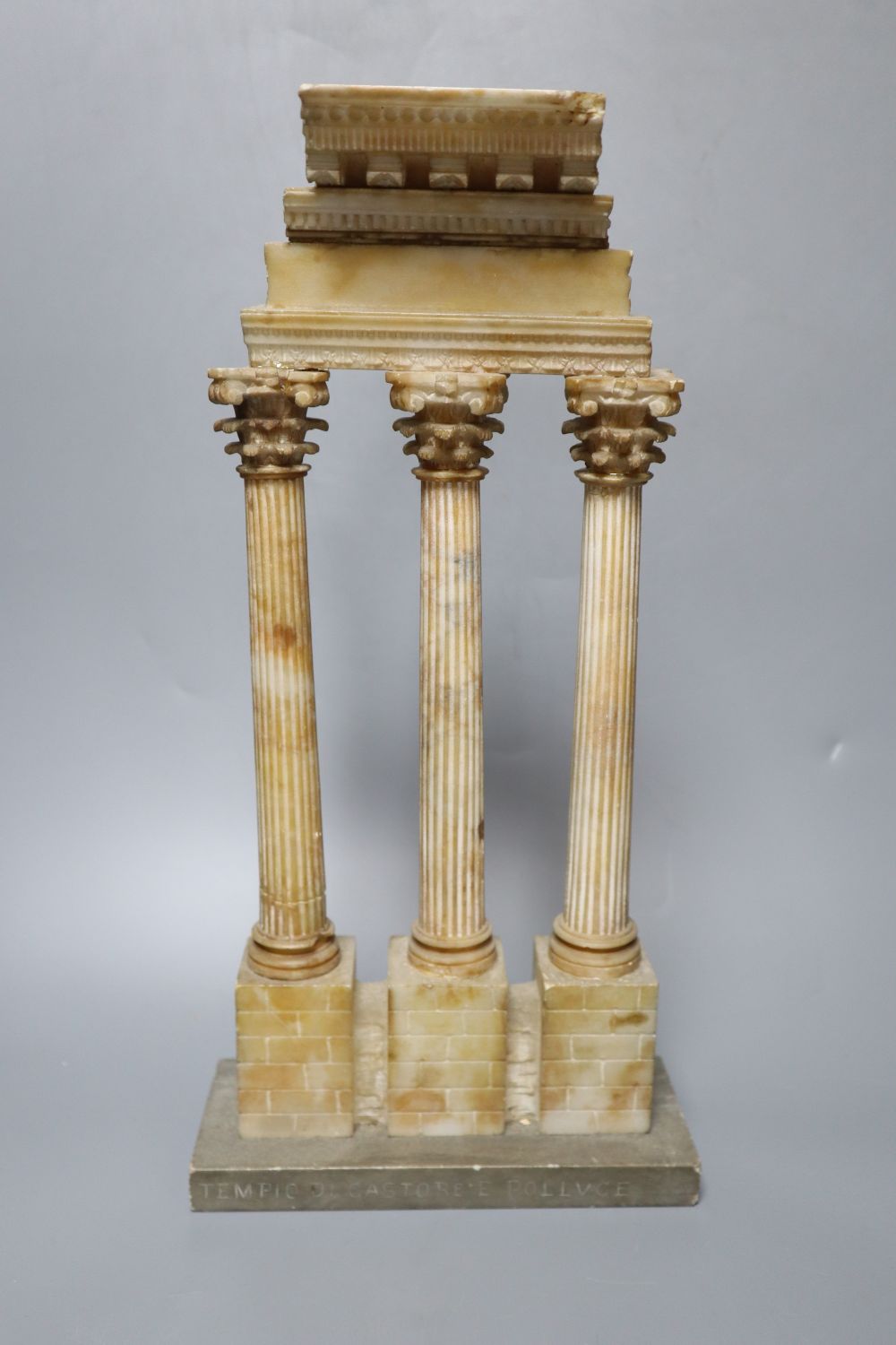 After the Antique. A Grand Tour carved and stained alabaster model of Ruins, height 34cm